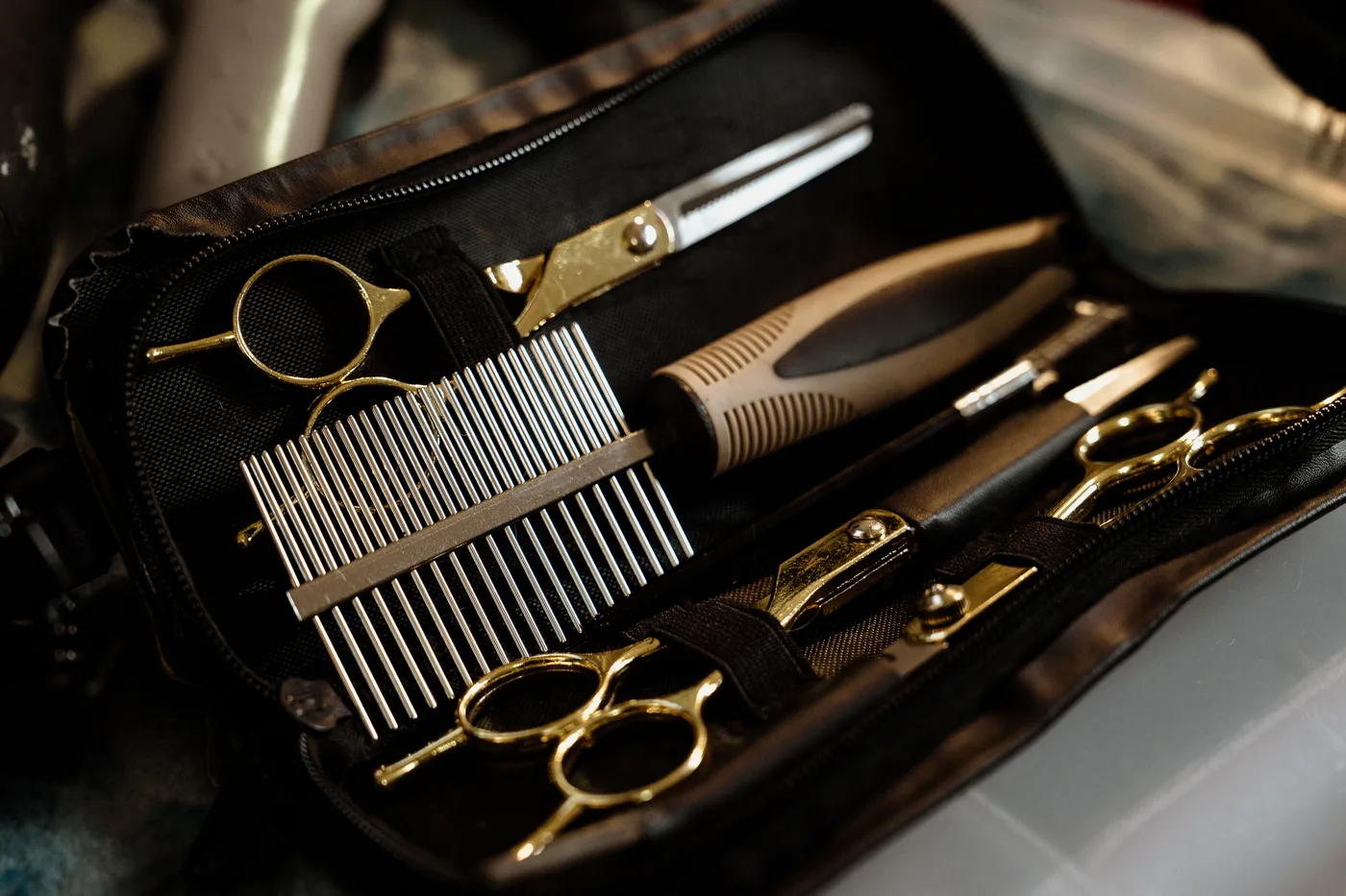 Professional grooming shears, combs and clippers laid out